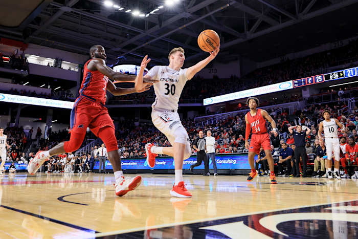 Nov 30, 2022; Cincinnati, Ohio, USA; Cincinnati Bearcats forward Viktor Lakhin (30) battles for the loose ball against N.J.I.T Highlanders forward Souleymane Diakite (21) in the first half at Fifth Third Arena. Mandatory Credit: Aaron Doster-USA TODAY Sports